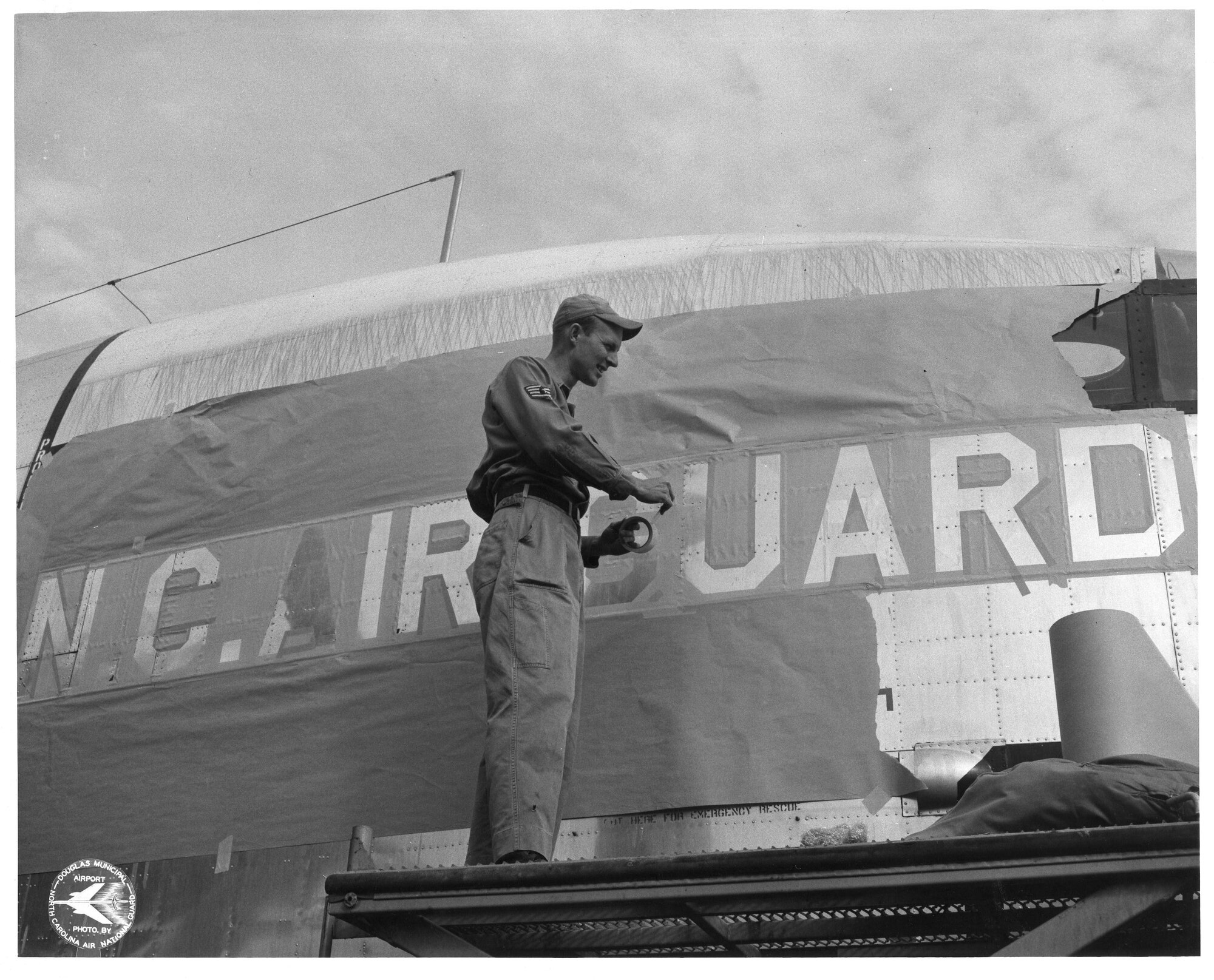 C-119 31 Jan 1961 - 19 Dec 1962; Charlie "Foggy" Millsaps Painting C-119 (Photo by NCANG Heritage Program)
