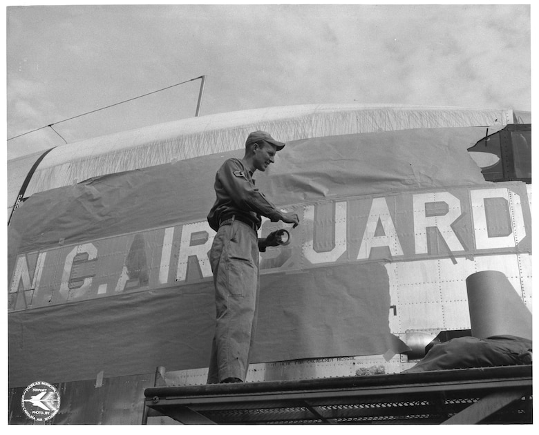 C-119 31 Jan 1961 - 19 Dec 1962; Charlie "Foggy" Millsaps Painting C-119 (Photo by NCANG Heritage Program)
