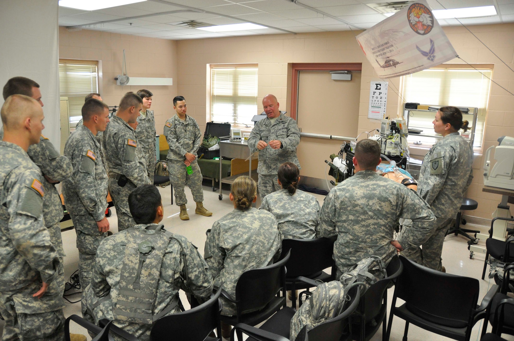 Maj. Don Brock, 934th Aeromedical Staging Squadron, provides hands on training to Army and Air Force Critical Care Air Transport Team members. (Air Force Photo/Senior Airman Jessica Coffin)