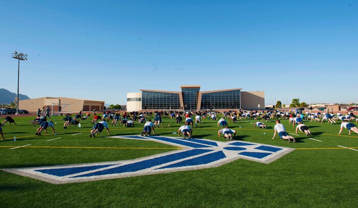 Members of the Nellis community perform push-ups during a Warrior Trained Fitness session with P90X workout creator Tony Horton, at the Warrior Fitness Center, June 17, 2014, Nellis Air Force Base, Nev. The push-ups were a part of a strength circuit to increase arm strength. (U.S. Air Force photo by Airman 1st class Rachel Loftis) 