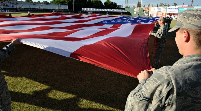 Team Beale presents the U.S. flag during the opening ceremony at the Marysville Gold Sox game June 14, 2014. The Gold Sox accommodated Spencer Draws, an Air Force Academy cadet and third baseman for the Gold Sox, to play for the team this summer. (U.S. Air Force photo by Airman 1st Class Ramon A. Adelan/ released)
