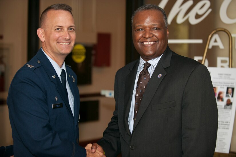 Col. William Knight, 11th Wing/Joint Base Andrews commander, shakes hands with Prince George’s County Executive Rushern L. Baker III here June 5, 2014, before signing the founding documentation for a “Way Ahead” initiative.
The Air Force initiative was created to leverage military installation and local community capabilities and resources with a goal of reducing operating costs in support of the Air Force mission.  (U.S. Air Force Photo/Staff Sgt. Robert Cloys)