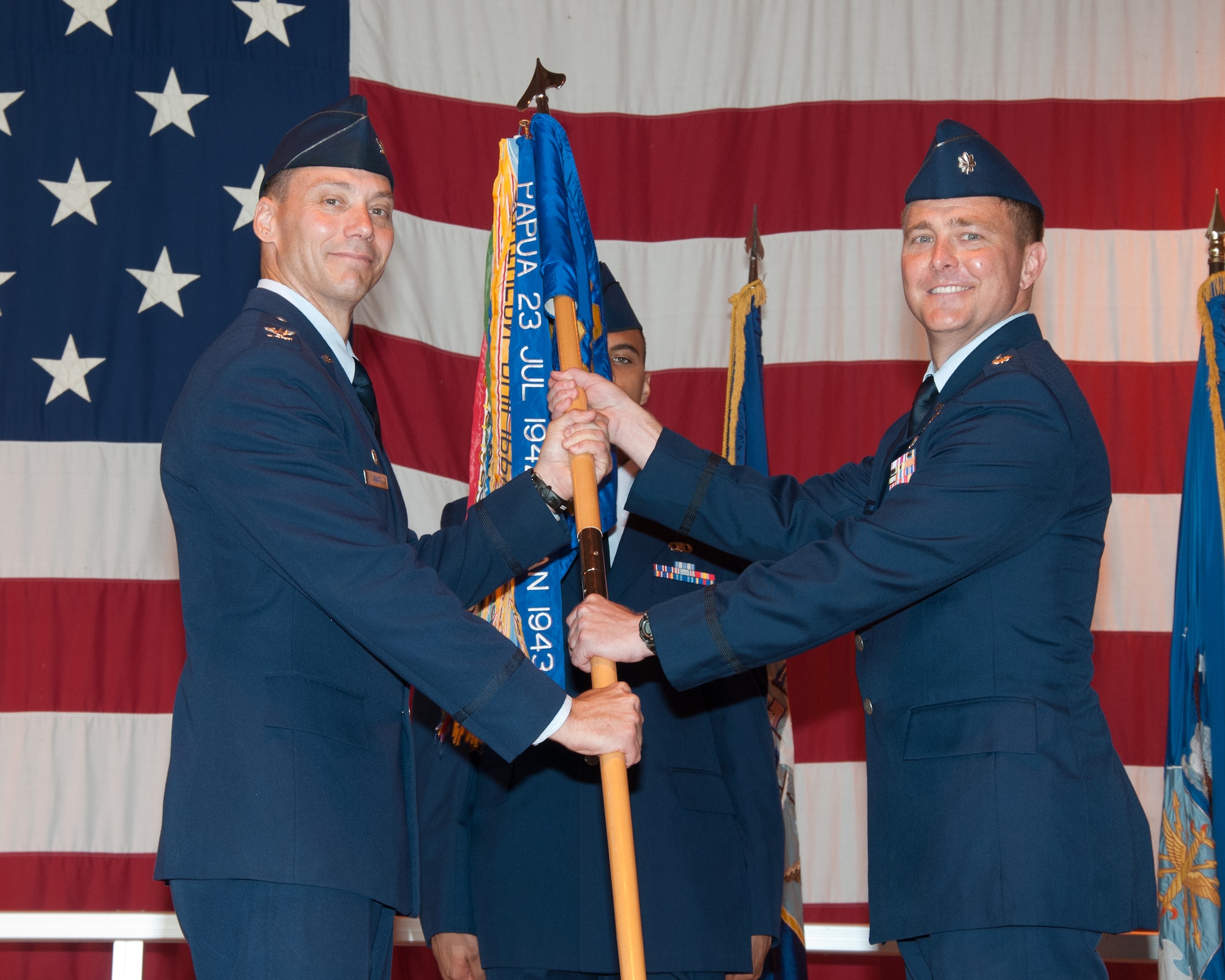VANCE AIR FORCE BASE, Okla. -- Lt. Col. Michael Starr, the 33rd Flying Training Squadron commander, takes the 33rd FTS guidon from Col. James Abatti, the 71st Operations Group commander, during a change-of-command ceremony June 16 at Hangar 170. Starr replaced Navy Cmdr. Christopher Narducci, who will be the last Navy pilot to command a Vance flying training squadron. (U.S. Air Force photo/Terry Wasson)