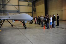 Civilian guests from local flying clubs and organizations recieve a tour of a hangar housing one of the MQ-1 Predators at Grand Forks Air Force Base, N.D. The viewing of MQ-1 Predators was part of tour given to people attending the 2014 M.A.C.A Civil Fly-In held June 14, 2014. (U.S. Air Force photo/Staff Sgt. Luis Loza Gutierrez)