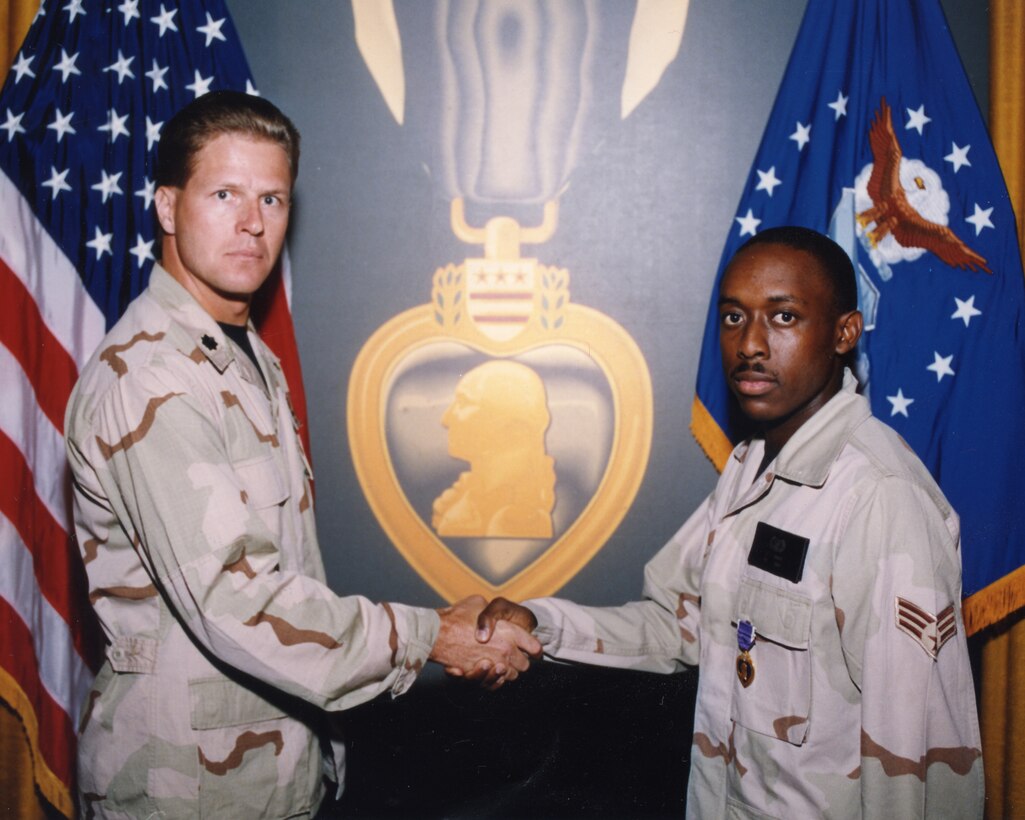 Lt. Col. Doug Cochran, 58th Fighter Squadron commander, presents Senior Airman Lee Wright with the Purple Heart for his actions following the Khobar Towers attack during a ceremony July 1996 at Eglin Air Force Base, Florida. (U.S. Air Force photo)