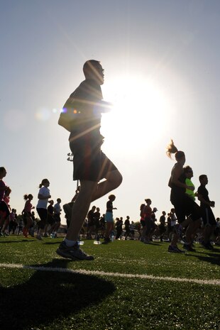 Members of the Nellis community work out during a Warrior Trained Fitness event hosted by Tony Horton, creator of the P90X workout, June 17, 2014 at Nellis Air Force Base, Nev.  The session, part of the “Life of a Warrior” program, included various exercises designed to increase strength and flexibility. (U.S. Air Force photo by Tech. Sgt. Taylor Worley)