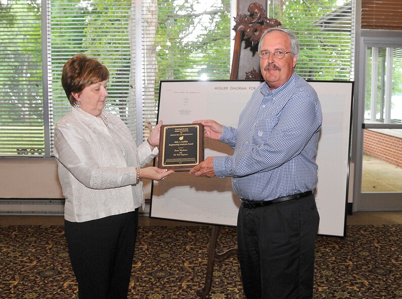 James Winchester (right), with the ATA Technology and Engineering Analysis Branch (TE), and Lt. Carl Tegtmeier (not shown), the AEDC Command executive officer, are the co-recipients of the Billy J. Griffith Engineering Analysis Award. They received the award for the development of safer and less environmentally hazardous methods for turbine flowmeter calibration. Martha Simmons, also with the ATA/TE, presents the award.