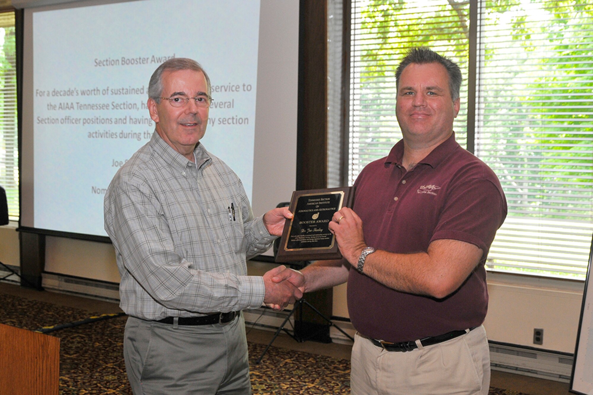 Joe Sheeley (right), with the ATA Technology and Engineering Analysis Branch (TE), receives the AIAA Booster Award for a decade sustained and outstanding service to the AIAA Tennessee Section. John Jordan, also with the ATA/TE, presents the award.
