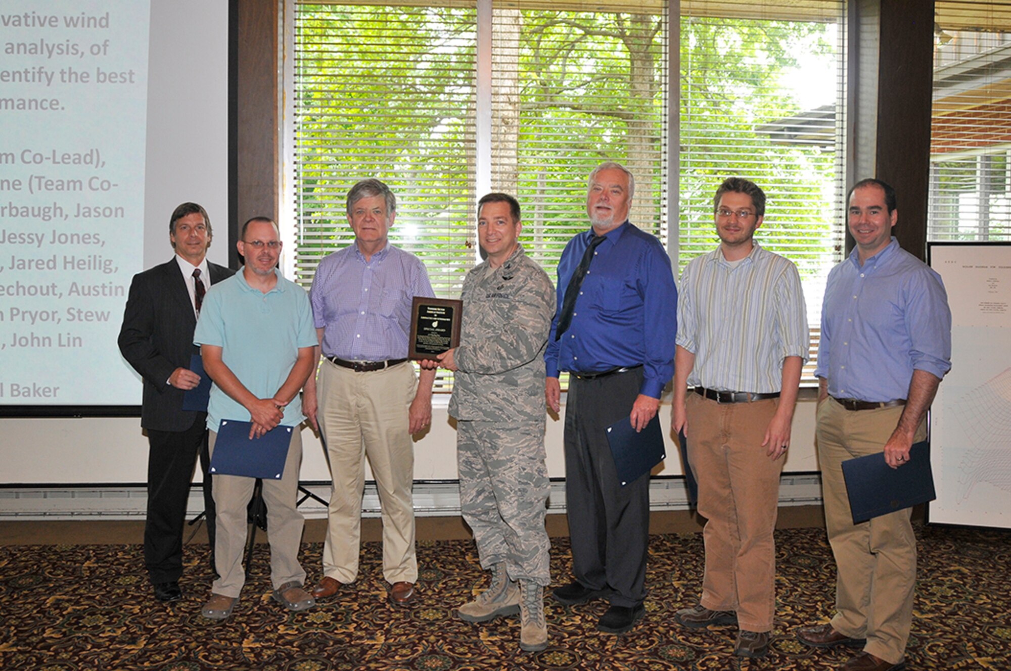 Col. Timothy West, from AEDC’s Test Operations Division, presents the AIAA Special Award to the A-10 Thunderbolt aircraft Wing Droop Team for the successful investigation of A-10 wing modifications for improved stall performance. Shown left to right are AEDC personnel Don Malloy, Jason Klepper, Grant Patterson, West, Milt Davis, Brian Binkley and Nathan Payne.