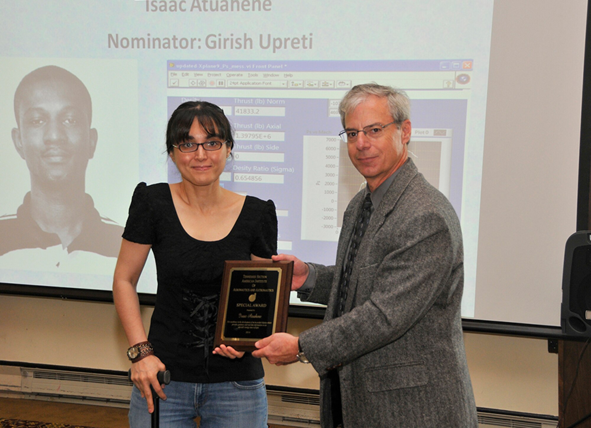 Densu Atkas (left), from the University of Tennessee Space Institute (UTSI), accepts an AIAA Special Award on behalf of Isaac Atuahene, currently with the University of Tennessee Knoxville, for his work on the development of an in-cockpit display for information on an aircraft’s energy state in flight. The award is presented by Joe Wehrmeyer, chairman of the AIAA Awards Committee.
