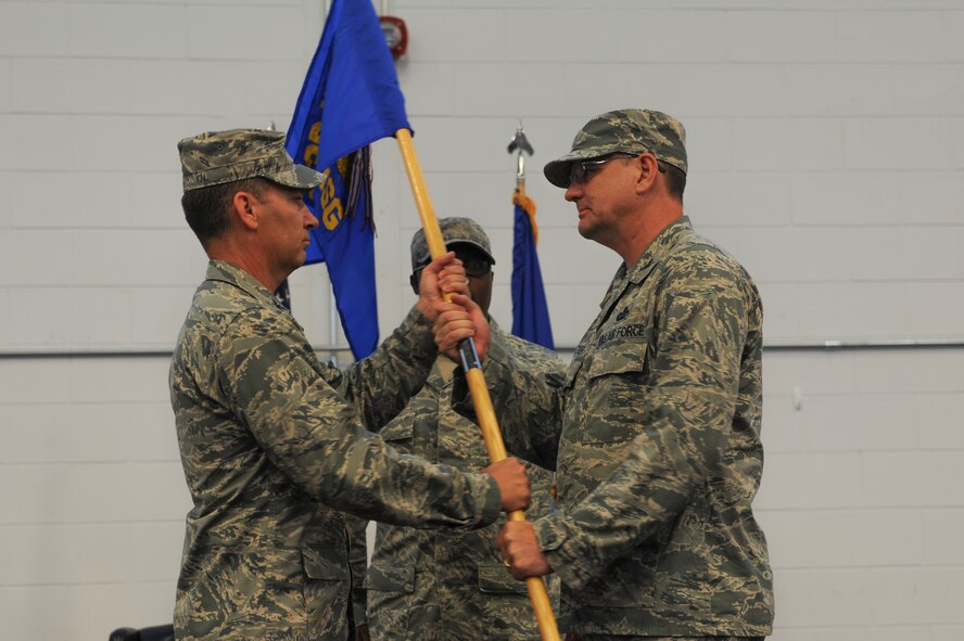 U.S. Air Force Col. Chad Franks, left, 23d Wing commander, passes the guidon to Col. Norman Dozier, 23d Mission Support Group commander, at Moody Air Force Base, Ga., June 18, 2014. The passing of the guidon symbolizes the transfer of authority. (U.S. Air Force photo by Airman 1st Class Alexis Millican/Released)