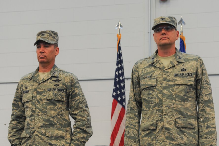 U.S. Air Force Col. Chad Franks, left, 23d Wing commander, and Col. Norman Dozier, 23d Mission Support Group commander, stand at attention during the MSG assumption of command at Moody Air Force Base, Ga., June 18, 2014. The 23d MSG is made up of six squadrons. (U.S. Air Force photo by Airman 1st Class Alexis Millican/Released)