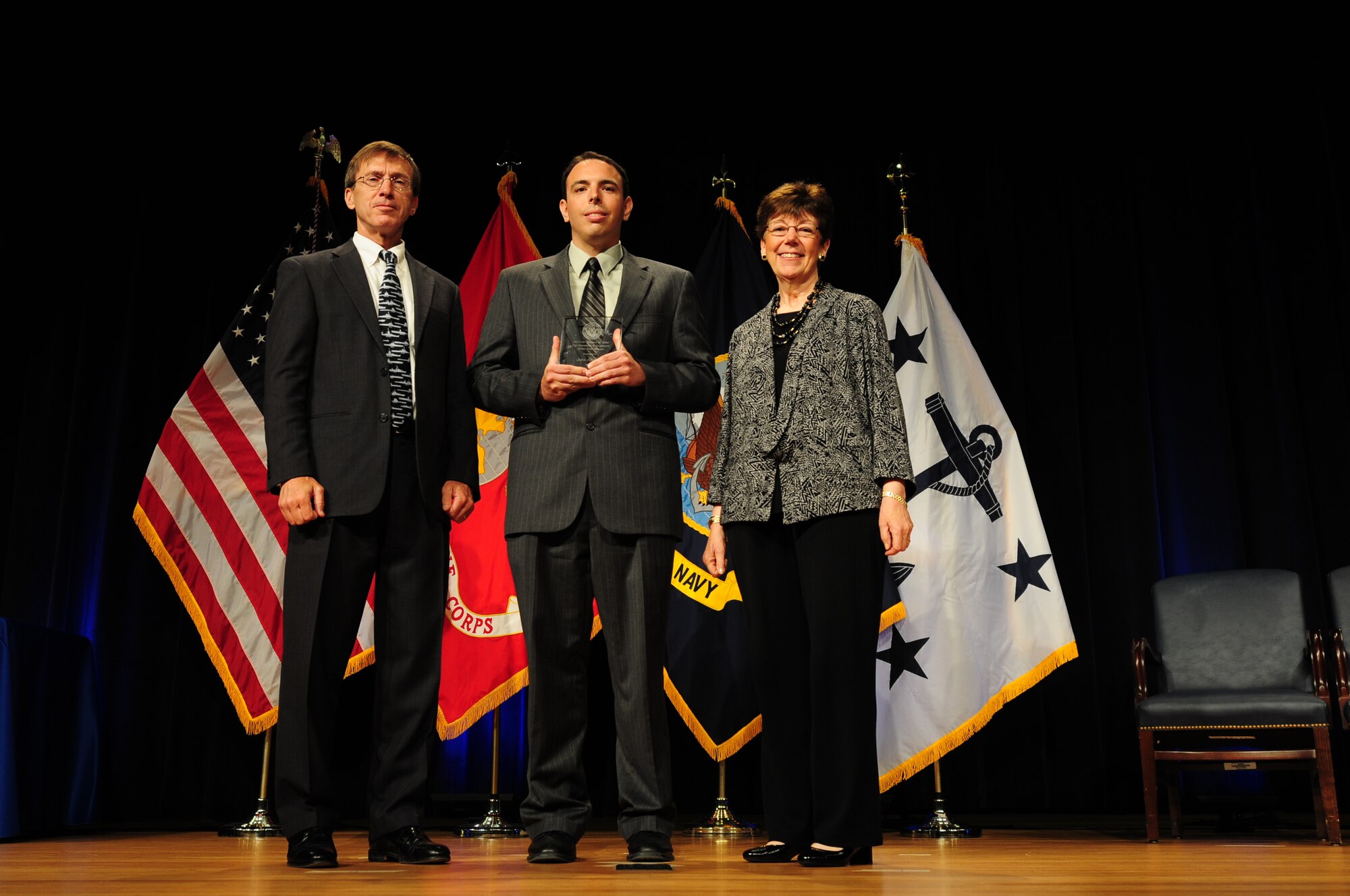 John Alotbelli receives the Dr. Delores M. Etter Top Scientists and Engineers of the Year Award for his work with service life management from Assistant Secretary of Navy Research, Development and Acquisition Sean Stackley and former ASN RDA, Dr. Delores M. Etter, for whom the award is named, on June 6, 2014, during a ceremony at the Pentagon. (Courtesy photo)