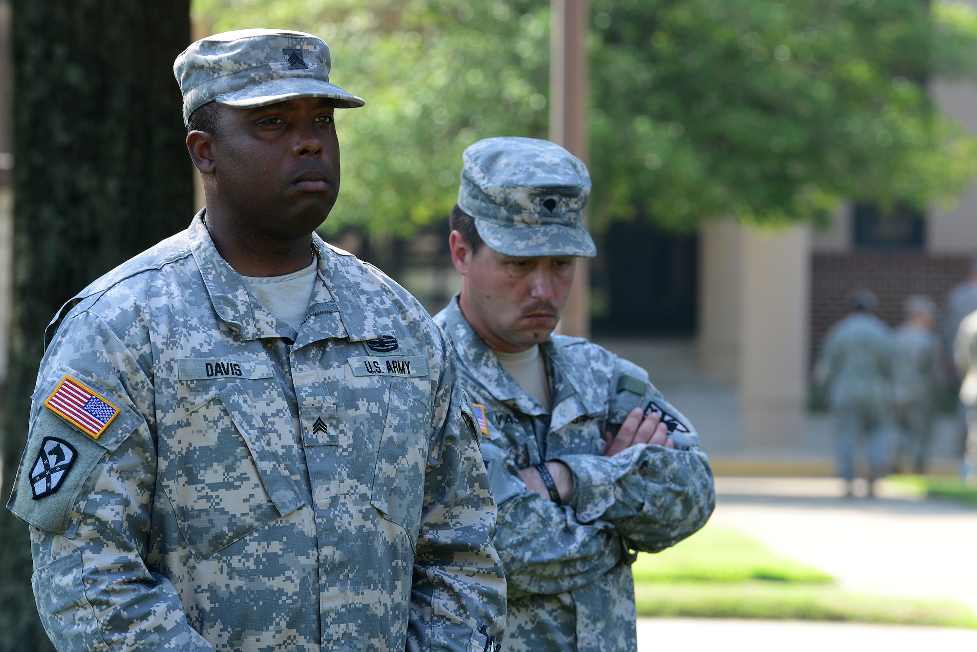U.S. Army Sgt. Richard Davis, left, 359th Inland Cargo Transfer Company, 10th Transportation Battalion, remembers a fallen comrade, Staff Sgt. Justin R. Johnson, at Fort Eustis, Va., June 18, 2014. The memorial was held on the one-year anniversary of when Johnson was killed in action during his tour in Afghanistan in 2013. (U.S. Air Force photo by Airman 1st Class Kimberly Nagle/Released)