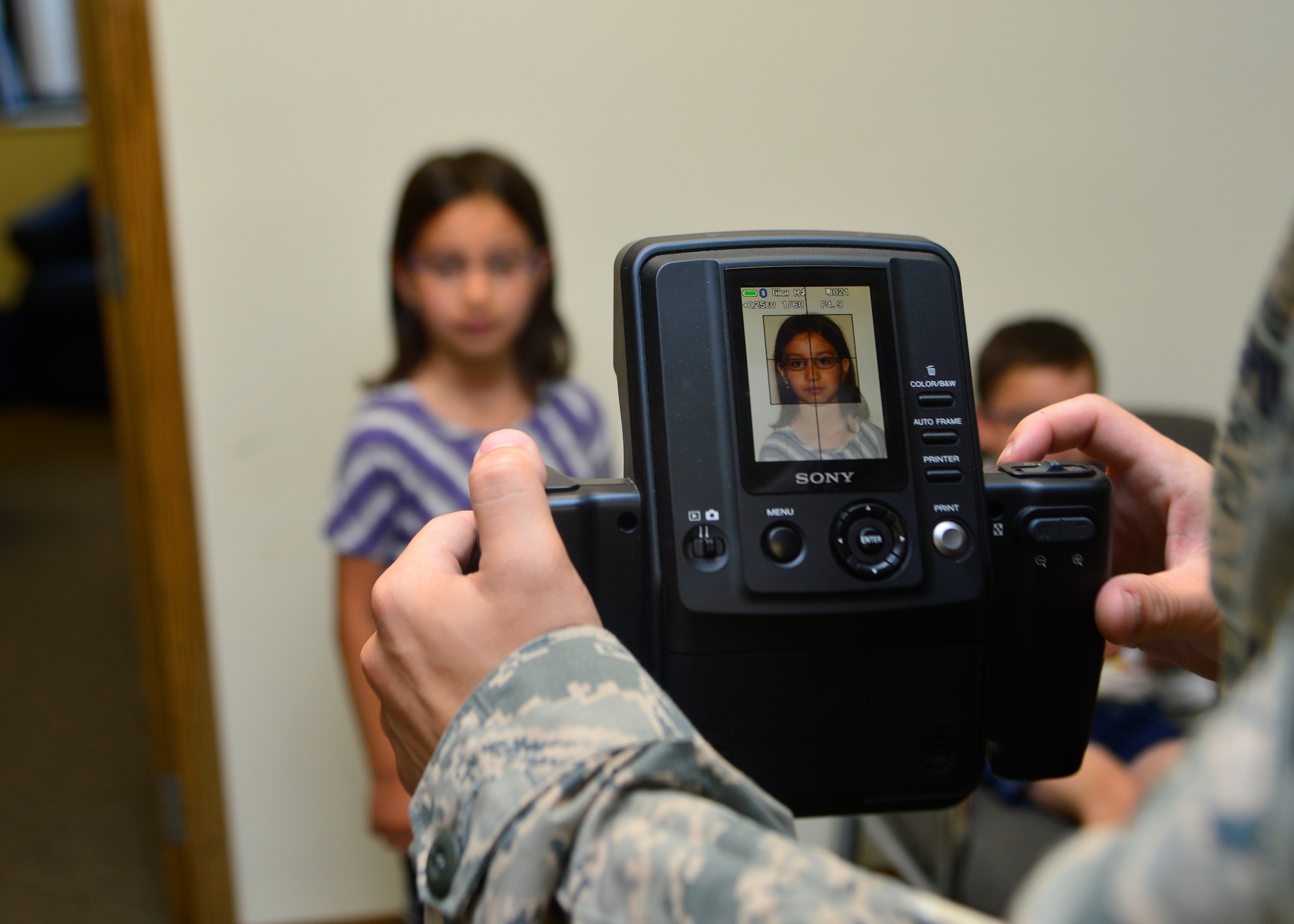 Trinity Dunn, daughter of Tech. Sgt. Gabriel Dunn, 736th Aircraft Maintenance Squadron programs coordinator, poses for a passport photo June 17, 2014, at Dover Air Force Base, Del. Dunn’s family needed passport photos for an upcoming permanent change of station to Incirlik Air Base, Turkey. (U.S. Air Force photo/Airman 1st Class William Johnson)