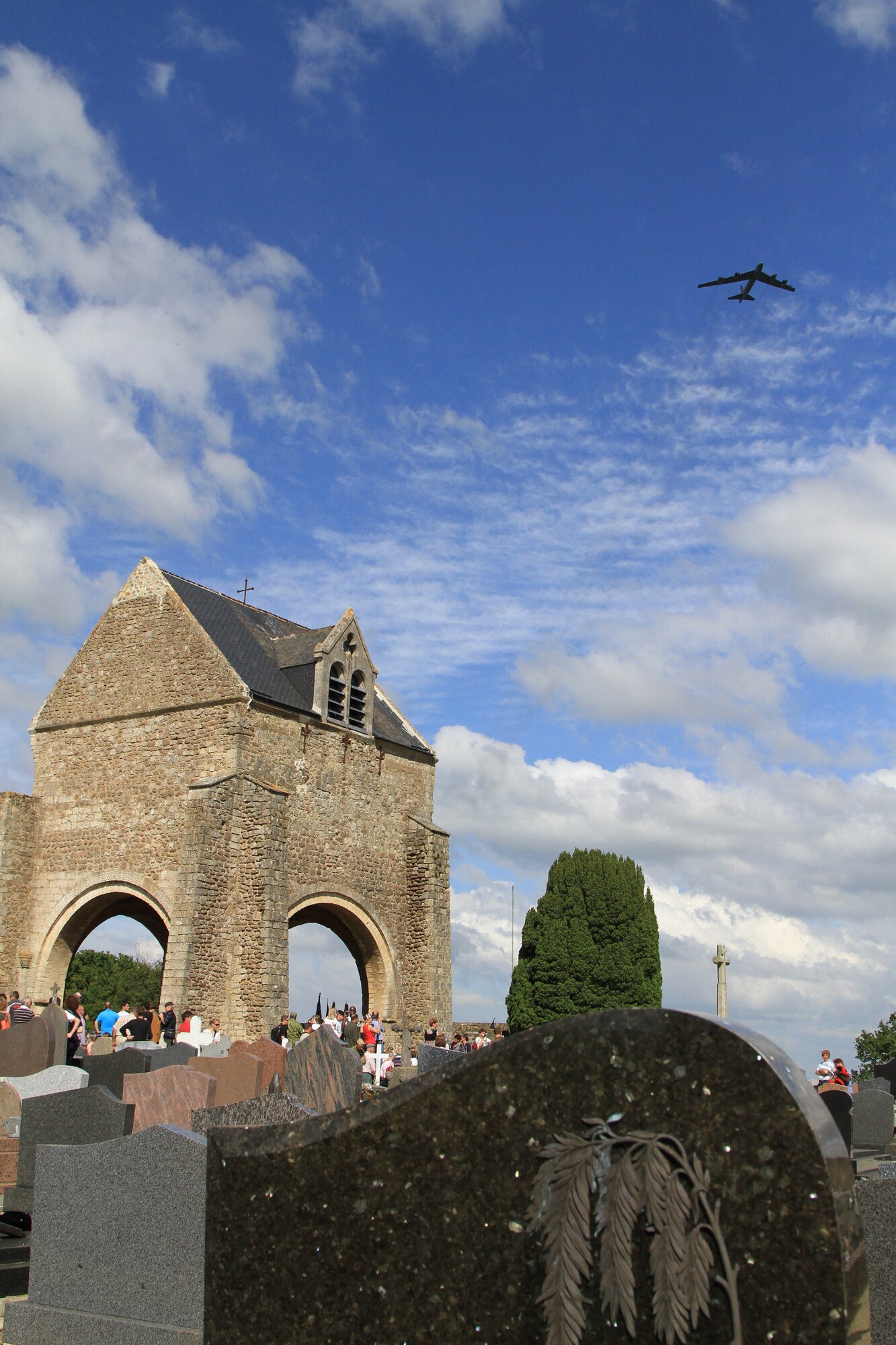 A B-52 deployed to RAF Fairford, UK, flies over a D-Day Memorial in Graignes, France, on June 7, 2014. (Courtesy Photo/Ben Quintana)