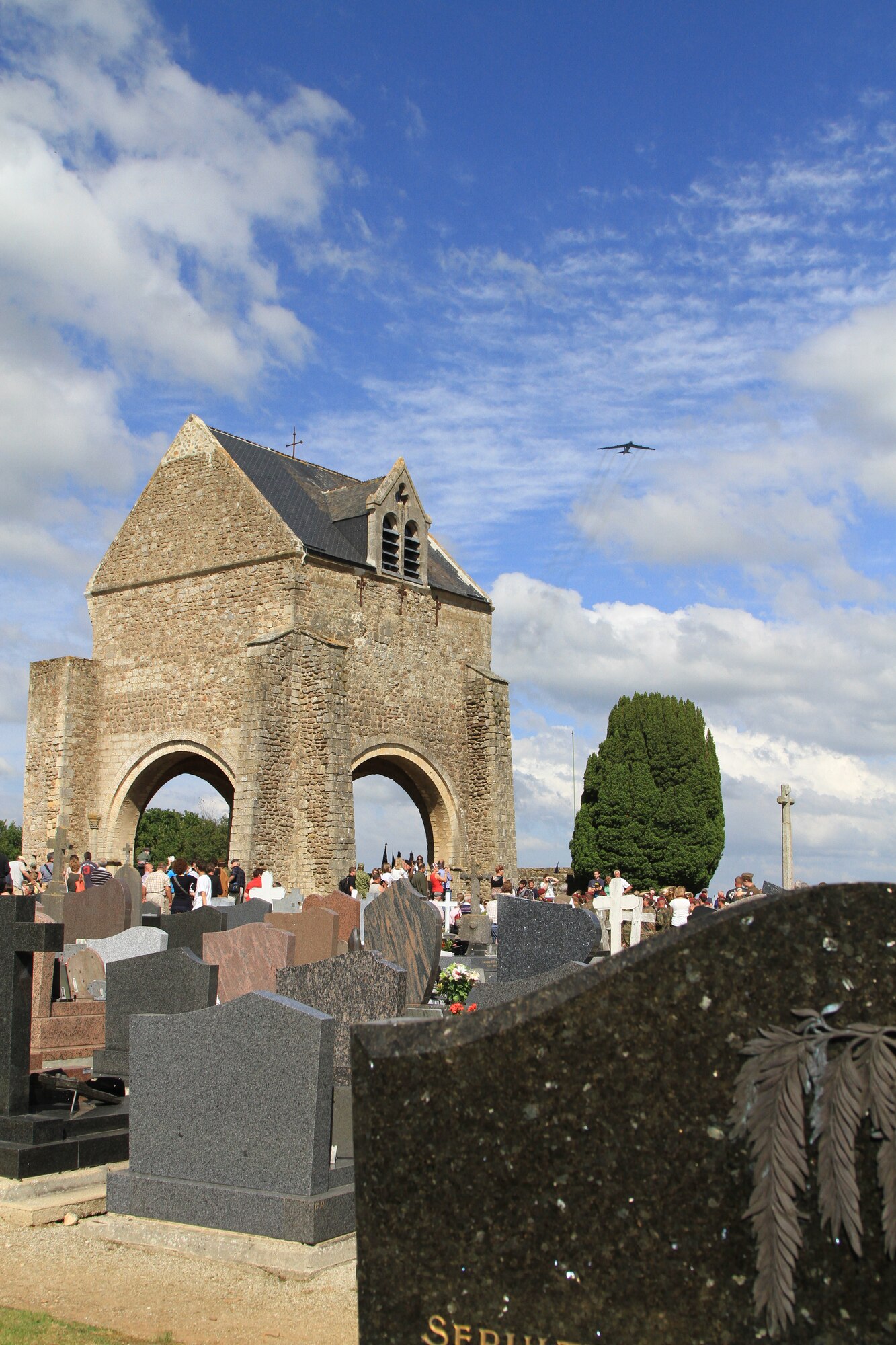 A B-52 deployed to RAF Fairford, UK, flies over a D-Day Memorial in Graignes, France, on June 7, 2014. (Courtesy Photo/Ben Quintana)