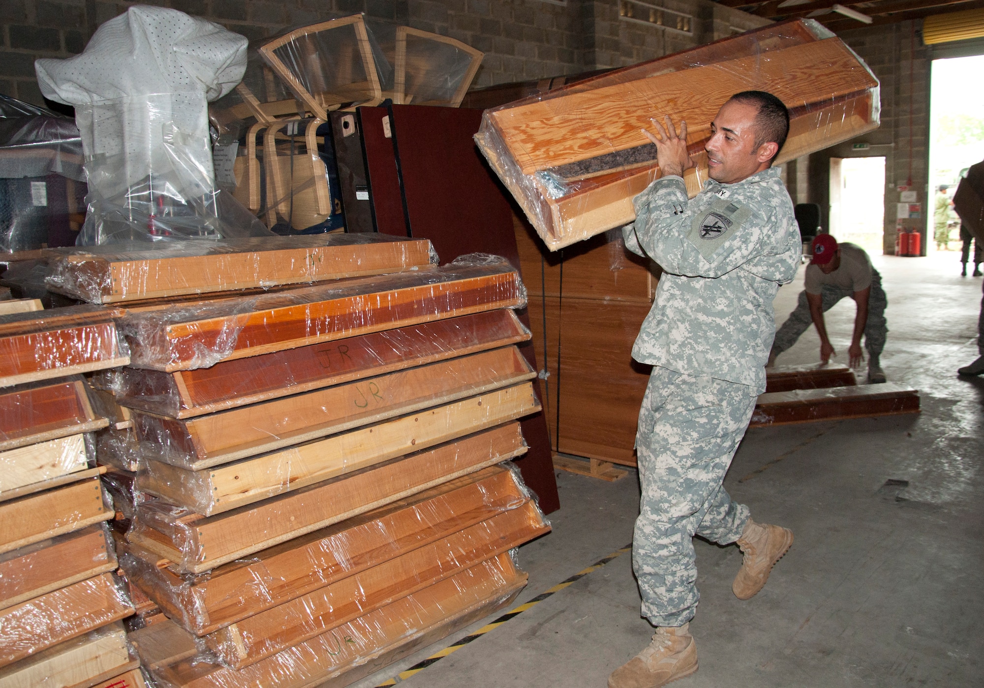 U.S. Army Sgt. 1st Class Chris Gomez, New Horizons Civil Affairs offloads donated supplies June 2, 2014, at the BDF Price Barracks in Ladyville, Belize. The civil affairs team worked with various non-government organizations, or NGOs, that donated school and medical supplies and furniture, and they also assisted during medical readiness training exercises in the northern Corozal District and southern Toledo District. (U.S. Air Force photo by Tech. Sgt. Kali L. Gradishar/Released)