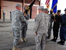 U. S. Army Lt. Col. Nicholas Dickson assumes command of the Army Forces Battalion at Soto Cano Air Base, Honduras by accepting the guidon from U. S. Army Col. Thomas Boccardi, the Joint Task Force-Bravo commander, June 16, 2014. Nicholson assumed command from outgoing commander U. S. Army Lt. Col. Alan McKewan. Army Forces Battalion is an expeditionary force ready to deploy as a resilient, integrated team capable of conducting administrative and logistical support for Joint Task Force-Bravo missions within Central America in order to counter illicit trafficking, support foreign humanitarian assistance/disaster relief and build partner nation capacity.  (Photo by Martin Chahin)