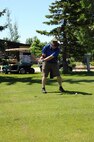 319th Air Base Wing Command Chief Master Sgt. David Duncan takes his first swing during the Military Affairs Committee golf tournament at Plainsview Golf Course on Grand Forks Air Force Base, N.D., June 17, 2014. Duncan was one of 52 golfers who participated in the annual event. (U.S. Air Force photo/Staff Sgt. David Dobrydney)