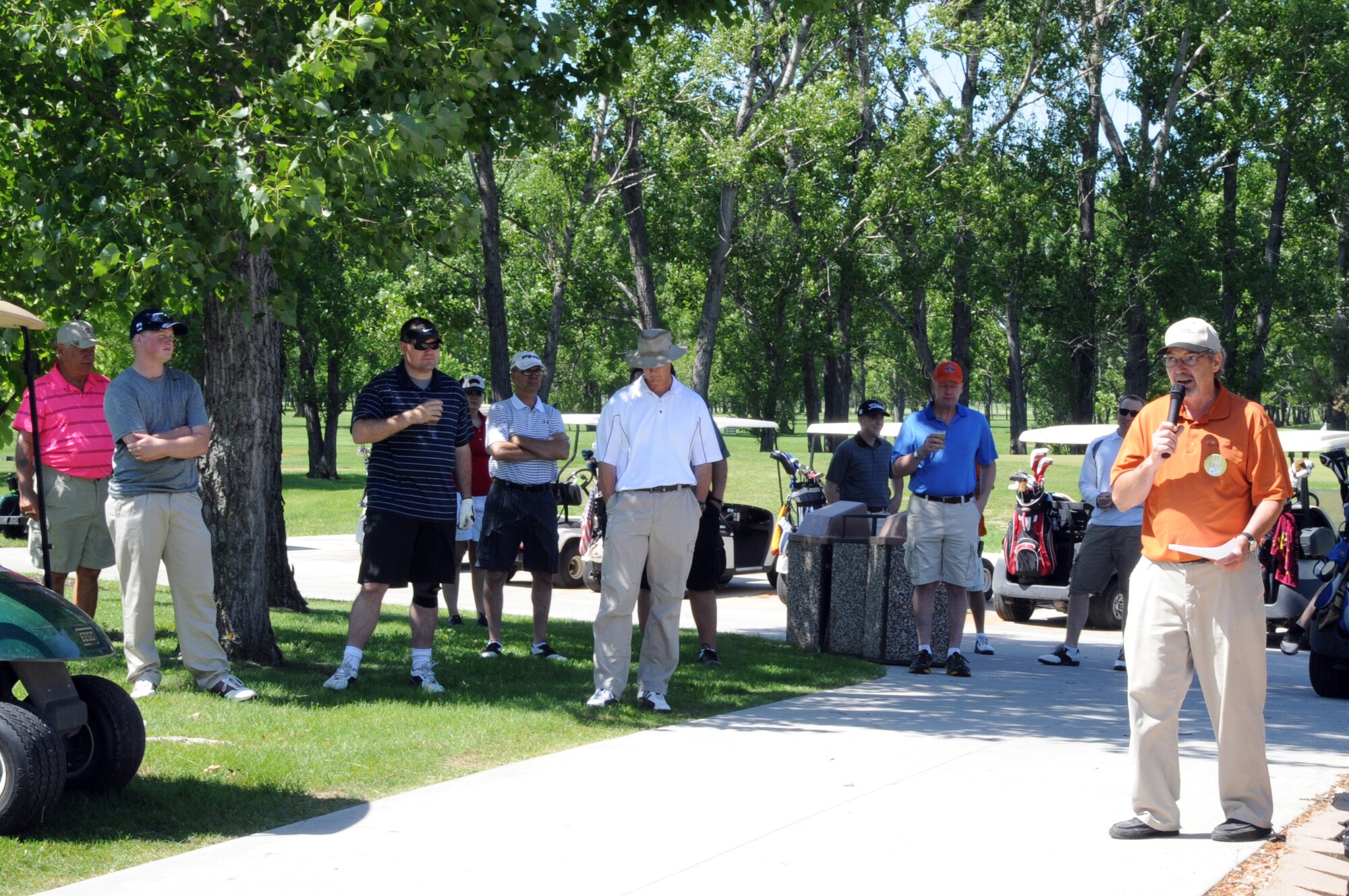 Stan Bruggeman, Plainsview Golf Course manager, reads some ground rules before the Military Affairs Committee golf tournament on Grand Forks Air Force Base, N.D., June 17, 2014. The tournament brought together military and civilian leaders in friendly competition to build relationships between the base and community. (U.S. Air Force photo/Staff Sgt. Dobrydney)