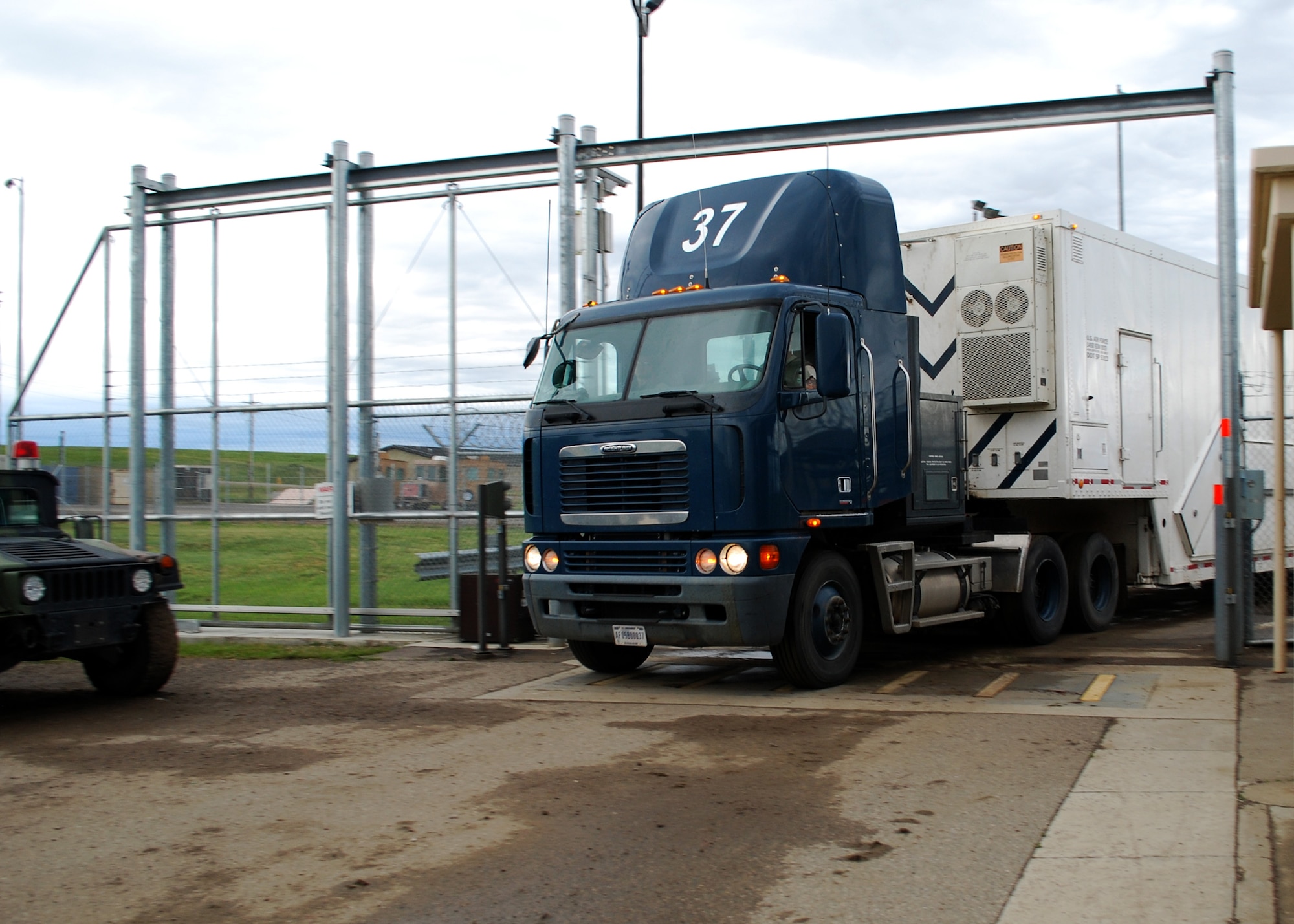 A payload transporter drives through the gate of the Malmstrom Air Force Base, Montana, weapons storage area June 16. The PT returned after maintenance crews removed the last multiple independently targetable reentry vehicle in the Air Force intercontinental ballistic missile inventory from a Minuteman III, helping bring the Air Force towards compliance with the New Strategic Arms Reduction Treaty and comply with direction from the 2010 Nuclear Posture Review. (U.S. Air Force photo/Senior Airman Katrina Heikkinen)