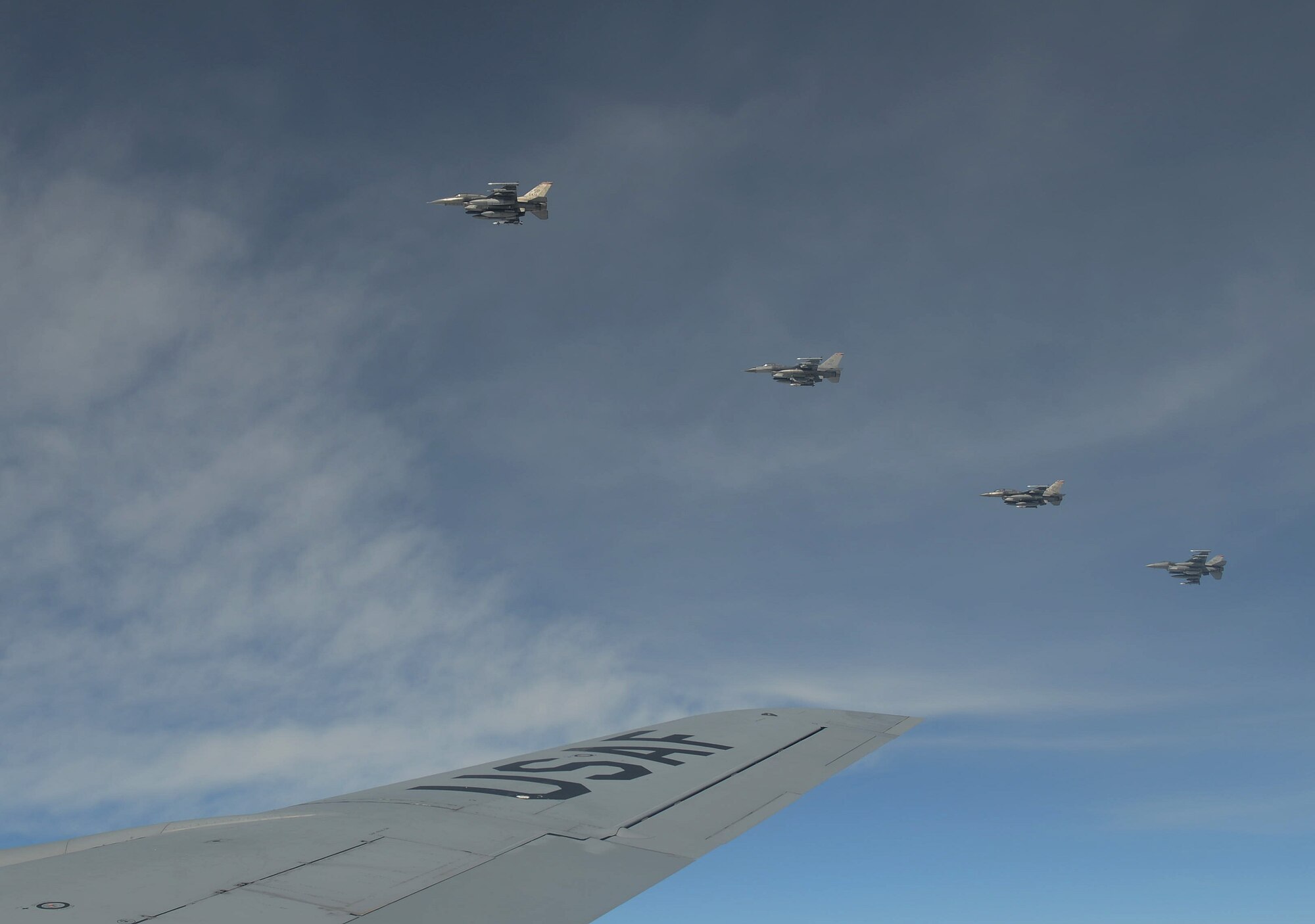 Four U.S. Air Force F-16 Fighting Falcons line up along the wing of a KC-135 Stratotanker after receiving fuel June 17, 2014, during a Baltic Operations Exercise mission over Poland. The U.S., its allies and partners in the Baltic region share common interest in maintaining a Europe that is safe, secure and prosperous. (U.S. Air Force photo/Airman 1st Class Kyla Gifford/Released)