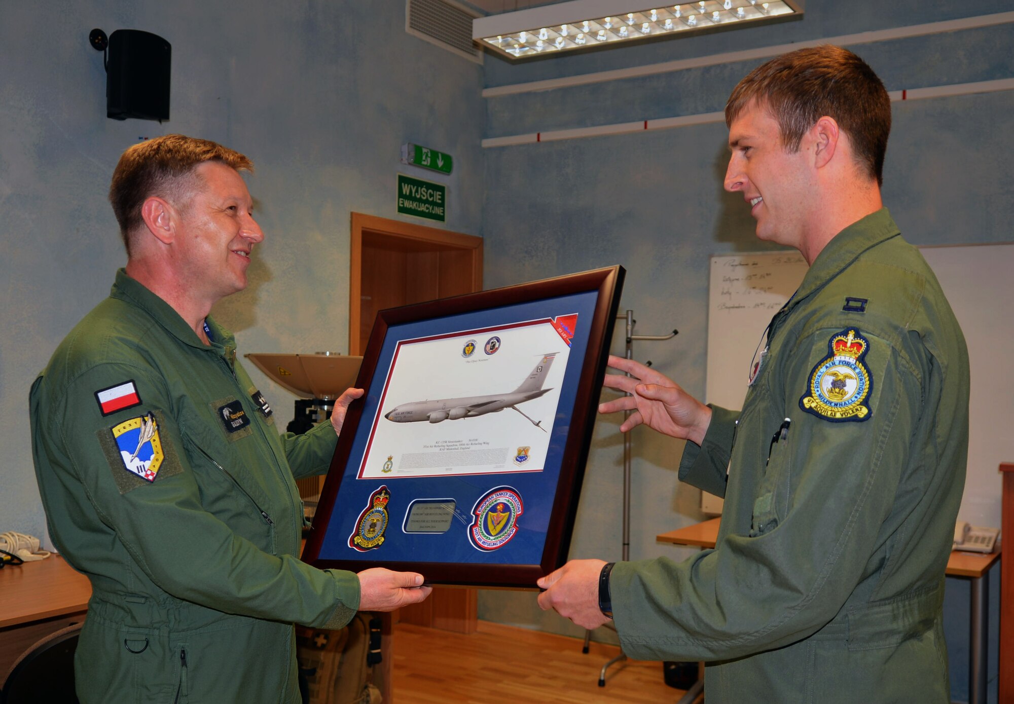 U.S. Air Force Capt. Patrick Edwards, right, 351st Expeditionary Air Refueling Squadron-Poland detachment commander, presents a thank you gift to Polish air force Col. Mieczyslaw Gaudyn, Powidz Air Base commander, June 17, 2014, on Powidz AB, Poland. The 351st EARS worked out of Poland to provide support for the 42nd annual Baltic Operations Exercise.  (U.S. Air Force photo/Airman 1st Class Kyla Gifford/Released)