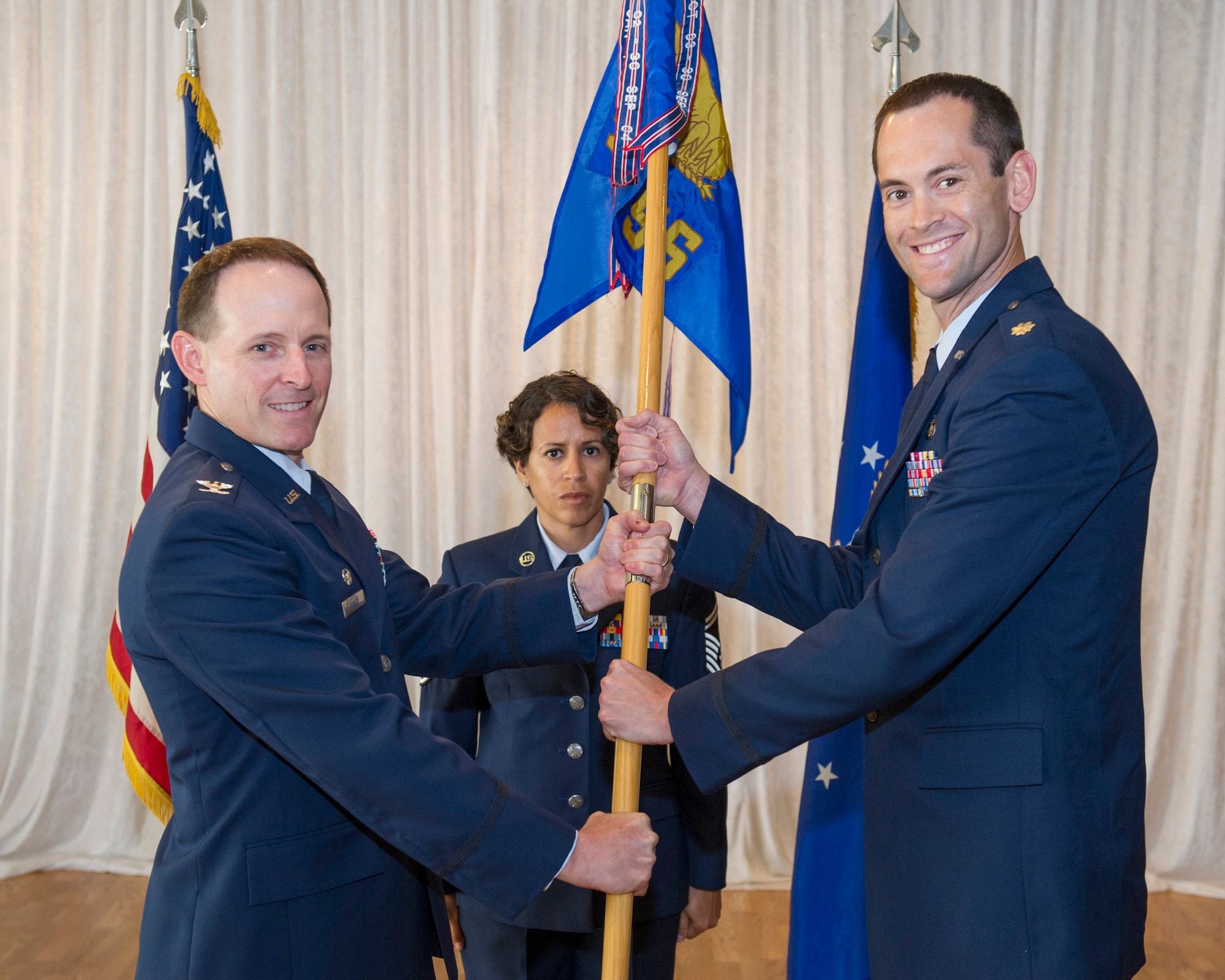 Col. Patrick Donley, 45th Mission Support Group commander, presents Maj. Paul Somers, 45th Force Support Squadron commander, with the 45th FSS guide-on during a change of command ceremony June 13, 2014, at Patrick Air Force Base, Fla. Changes of command are a military tradition representing the transfer of responsibilities from the presiding officials to the upcoming official. (U.S. Air Force photo/Cory Long)