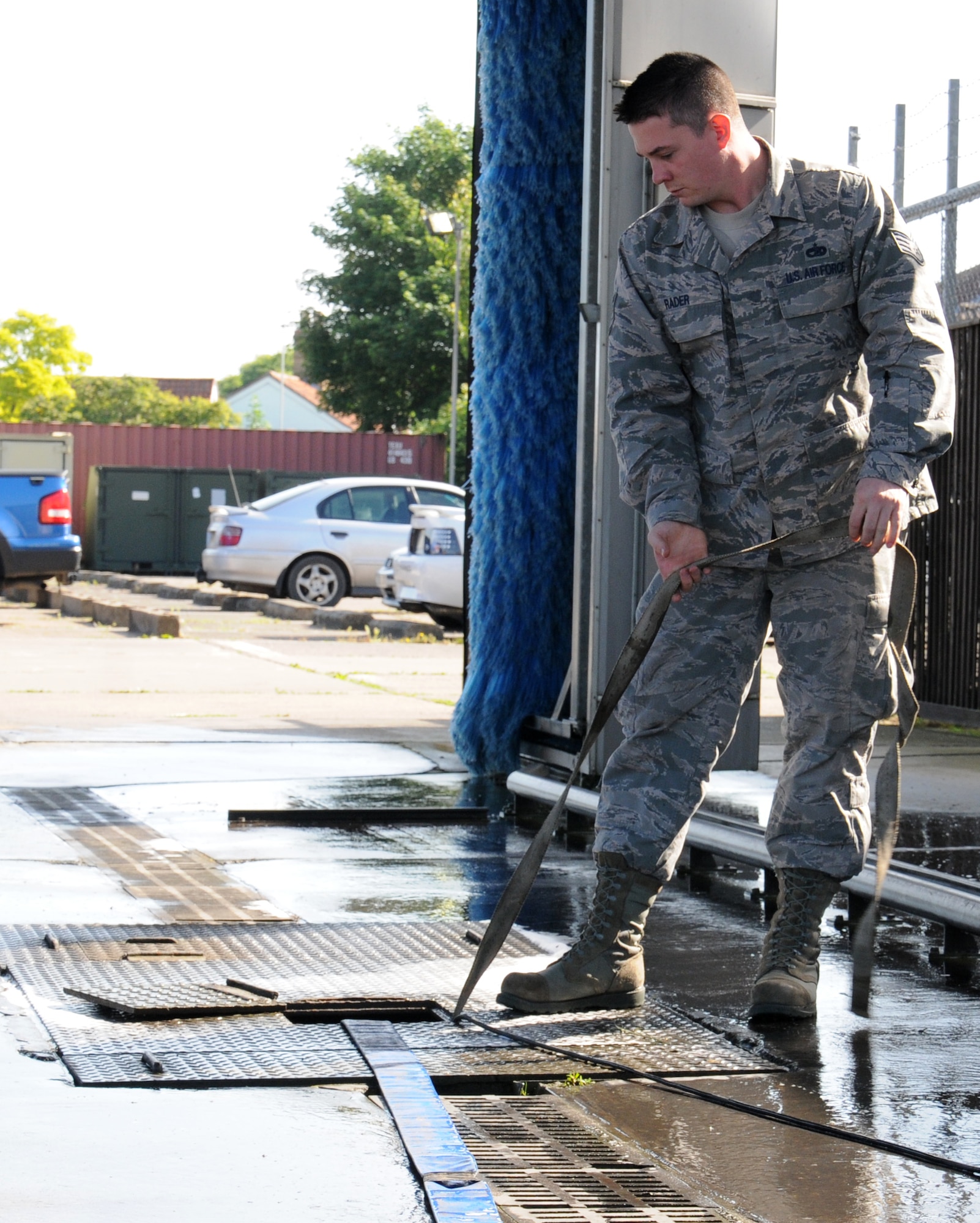 U.S. Air Force Staff Sgt. Ryin Rader, 100th Logistics Readiness Squadron NCO in charge of equipment support from Keyser, W.Va., cleans the drains of the wash rack June 13, 2014, on RAF Mildenhall, England. Ensuring the wash rack is serviceable is important to the 565 vehicles assigned to RAF Mildenhall. It’s a requirement to drain the system regularly to remove any foreign objects that may be blocking the water recycling system. (U.S. Air Force photo/Gina Randall/Released)