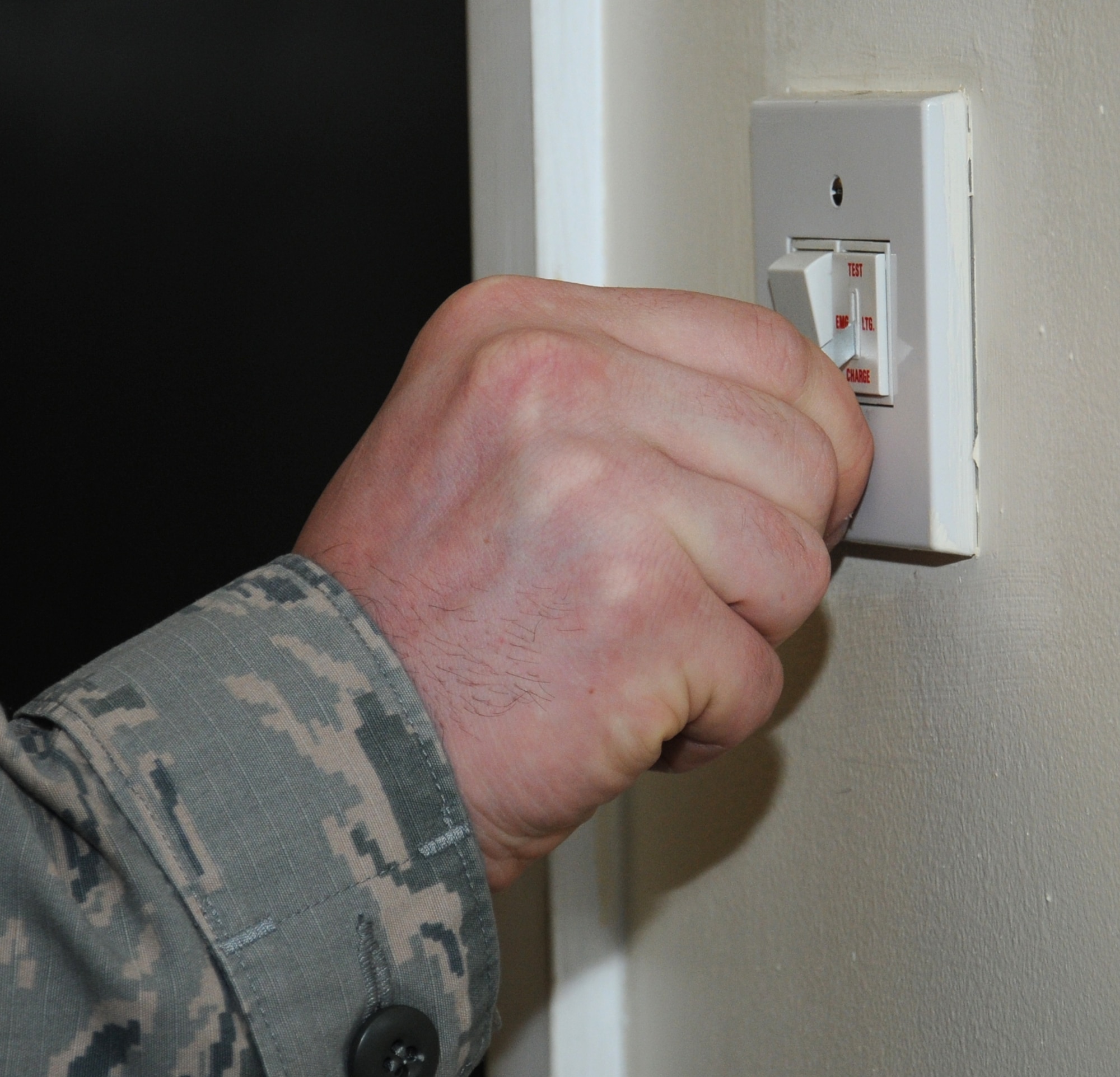 U.S. Air Force Staff Sgt. Ryin Rader, 100th Logistics Readiness Squadron NCO in charge of equipment support from Keyser, W.Va., checks the emergency lights June 13, 2014, on RAF Mildenhall, England. Rader checks all emergency lights within the first few days of every month, as they are a safety requirement. (U.S. Air Force photo/Gina Randall/Released)