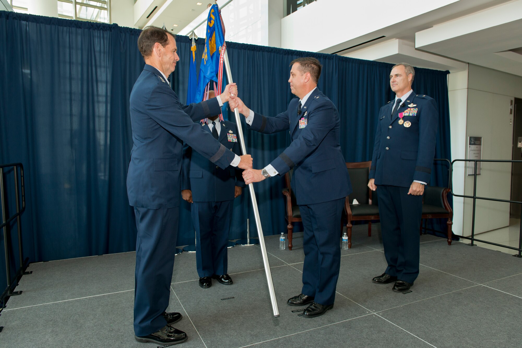 Brig. Gen. Michael R. Taheri, commander of the Air National Guard Readiness Center, assumes command of the ANGRC from Lt. Gen. Stanley E. Clarke III, the director of the ANG, during an assumption of command ceremony June 16, 2014 at the ANGRC, Joint Base Andrews, Md. Brig. Gen. R. Scott Williams (right) is the outgoing commander. The ANGRC ensures ANG field units are properly resourced to train and equip in support of the state and federal missions across the entire spectrum of military operations and provide support sustaining ANG Airmen throughout their careers. (Air National Guard photo by Master Sgt. Marvin Preston/Released)