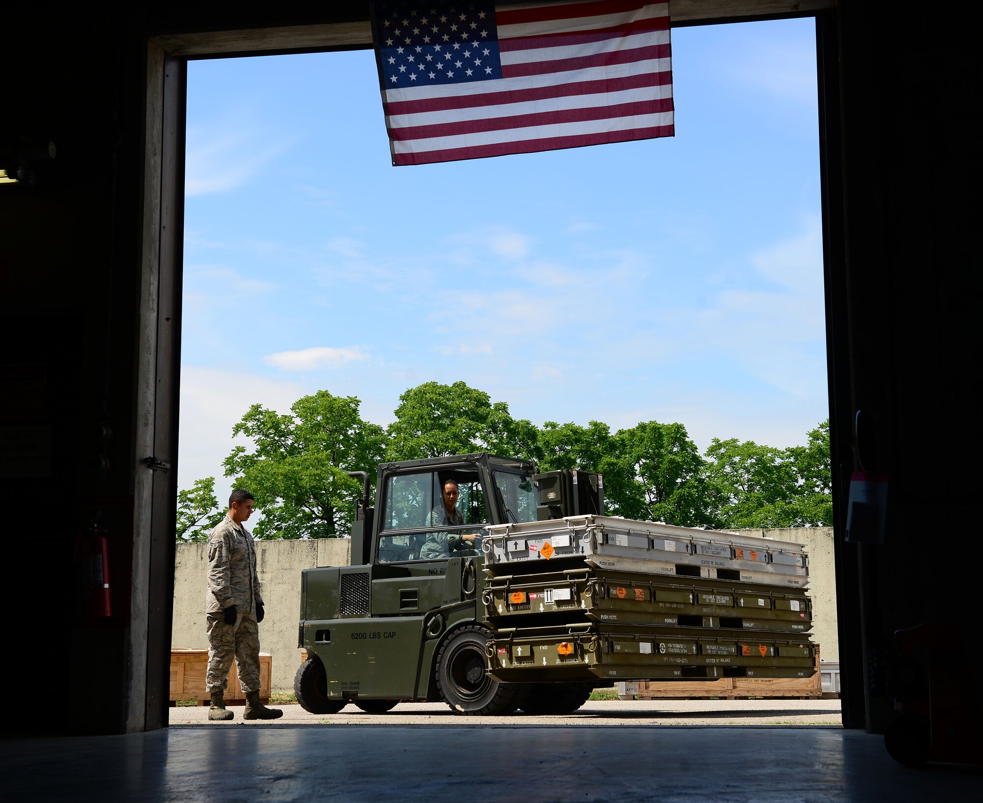 Airman 1st Class Shayla Hasbrouck, 31st Munitions Squadron storage crew member, drives a forklift into a munitions facility, June 16, 2014, at Aviano Air Base, Italy. To ensure maximum safety, members from the 31st MUNS take proper precautions when handling all munitions. (U.S. Air Force photo/Senior Airman Matthew Lotz)