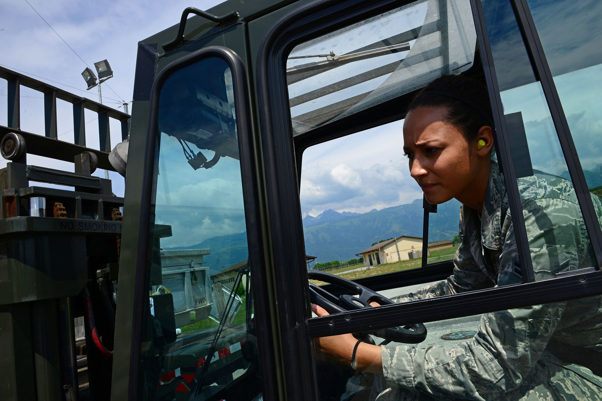 Airman 1st Class Shayla Hasbrouck, 31st Munitions Squadron storage crew member, uses a forklift to carry munition containers, June 16, 2014, at Aviano Air Base, Italy. To ensure maximum safety, members from the 31st MUNS take proper precautions when handling all munitions. (U.S. Air Force photo/Senior Airman Matthew Lotz)