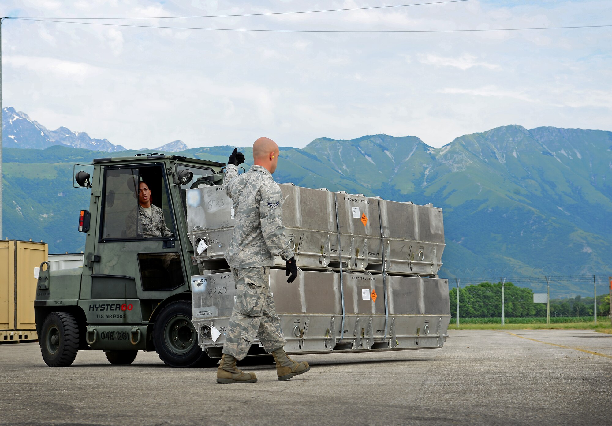 Airman 1st Class Justin Childers, directs Airman 1st Class Gerald Gutierrez, 31st Munitions Squadron storage crew members, June 12, 2014, at Aviano Air Base, Italy. The storage section pulls the necessary munitions and coordinates transportation between the geographically-separated locations with agencies such as security forces, Italian security forces and carabinieri. (U.S. Air Force photo/Senior Airman Matthew Lotz)