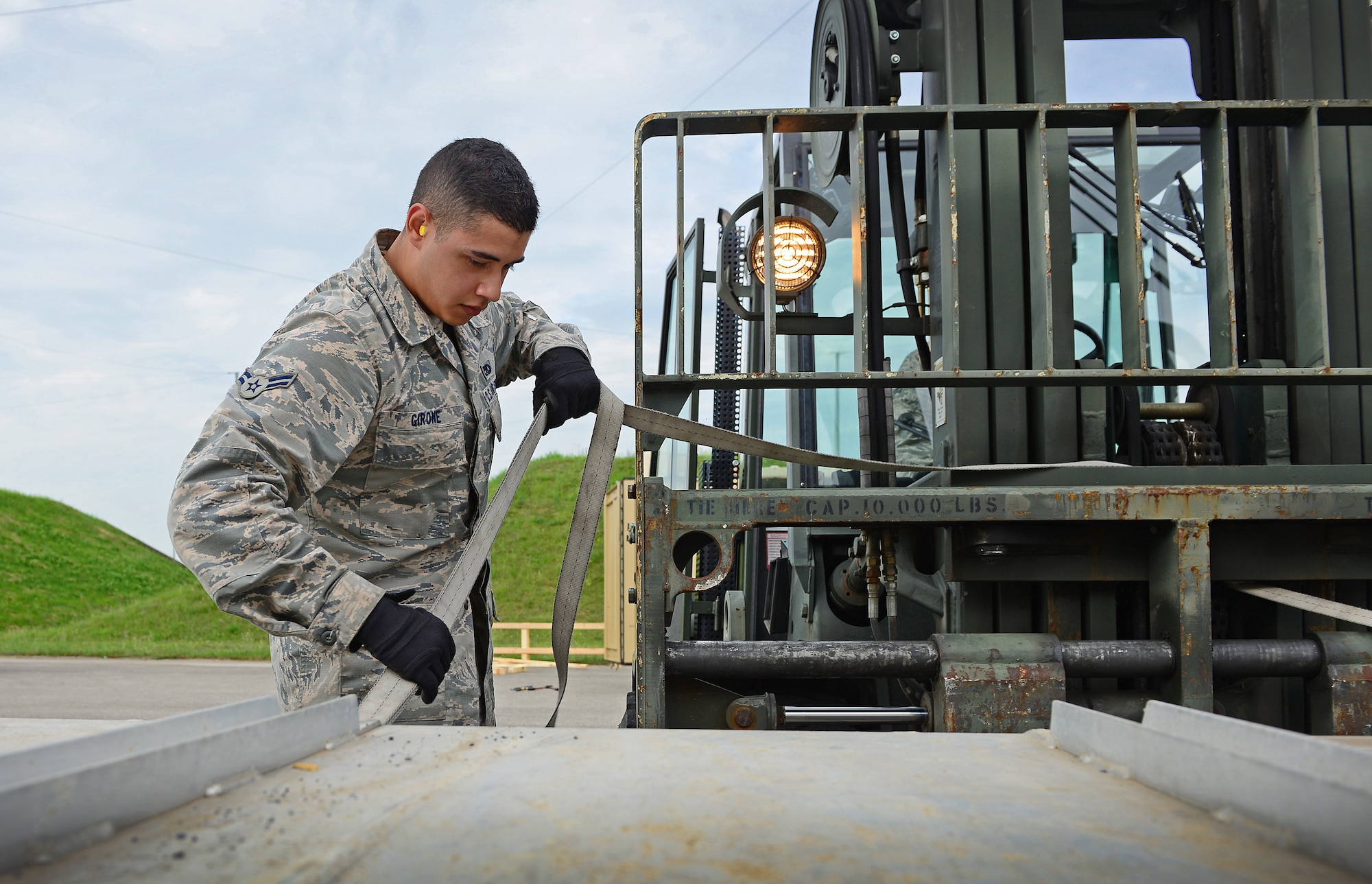 Airman 1st Class Joseph Girone Jr., 31st Munitions Squadron storage crew member, straps a munitions box down, June 12, 2014, at Aviano Air Base, Italy. The 31st MUNS storage section is responsible for providing transportation and storage for a multi-million-dollar stockpile of munitions for the 510th and 555th Fighter Squadrons and the 31st Security Forces Squadron.  (U.S. Air Force photo/Senior Airman Matthew Lotz)