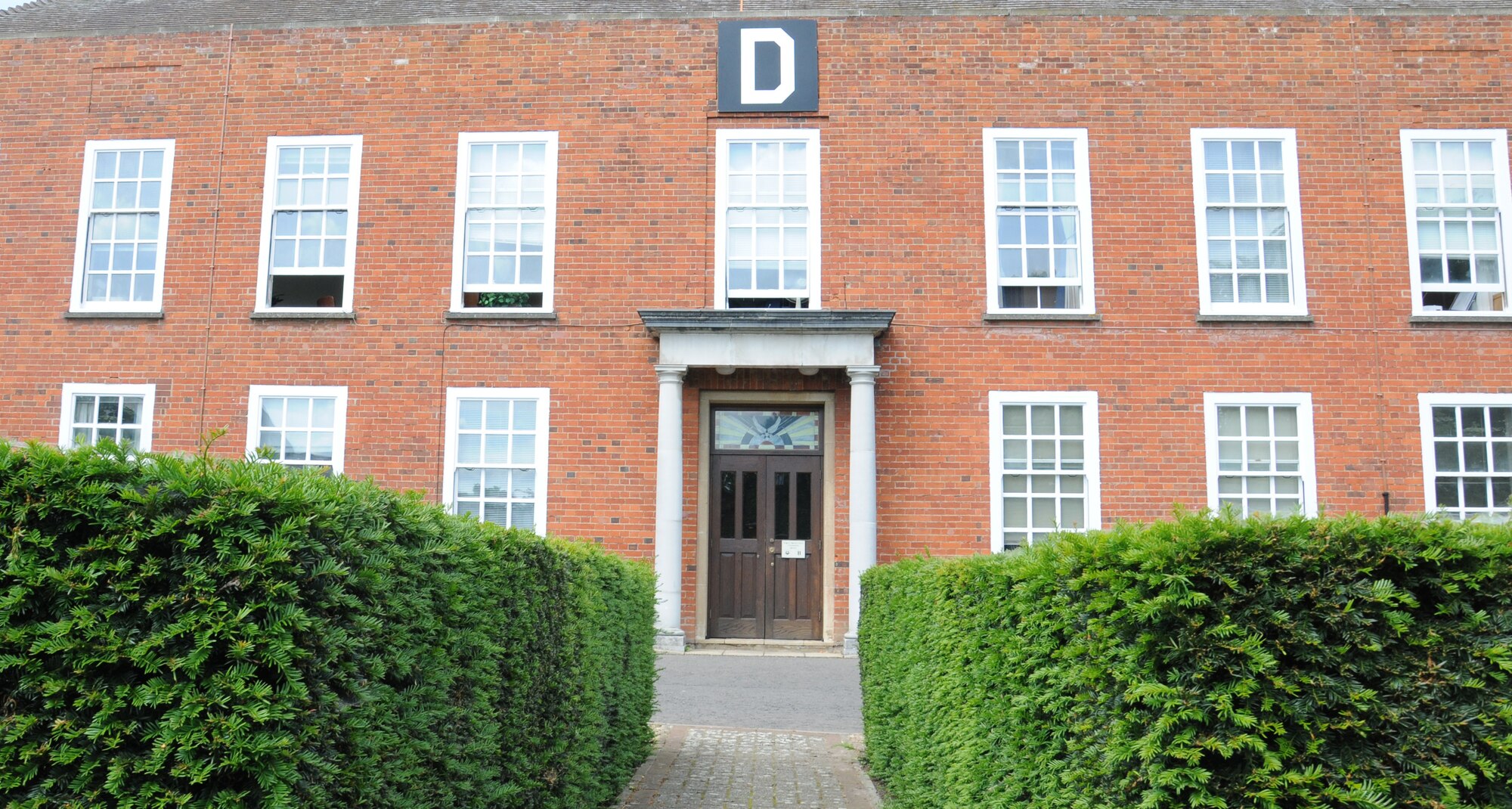 The 100th Air Refueling Wing headquarters building is home to the new historical library June 11, 2014 on RAF Mildenhall, England. U.S. Air Force Col. Daniel Merry, 100th Mission Support Group commander, and Mark Howell, 100th ARW historian from Odessa, Texas, pooled their book resources and created a historical library for the base population. (U.S. Air Force photo/Gina Randall/Released)