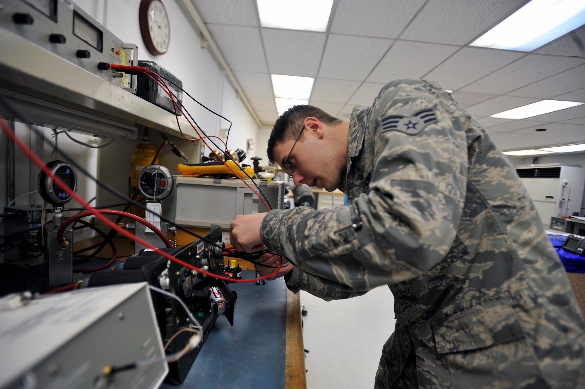 Senior Airman Matthew Furlough, 51st Maintenance Squadron physical dimensional precision measurement equipment laboratory technician, makes an adjustment on an engine warning test set on Osan Air Base, Republic of Korea, June 6, 2014. The unit repairs equipment ranging from torque wrenches, spectrum analyzers, communication analyzers, avionics equipment, scales and gun gauges. (U.S. Air Force photo/Senior Airman David Owsianka)