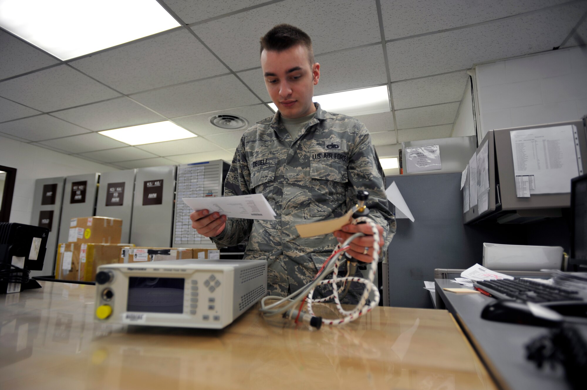 Staff Sgt. Noel Deuell, 51st Maintenance Squadron production control NCO in charge, processes a work order for a power meter on Osan Air Base, Republic of Korea, June 6, 2014. The laboratory receives 20 to 30 items for repair daily. (U.S. Air Force photo/Senior Airman David Owsianka)