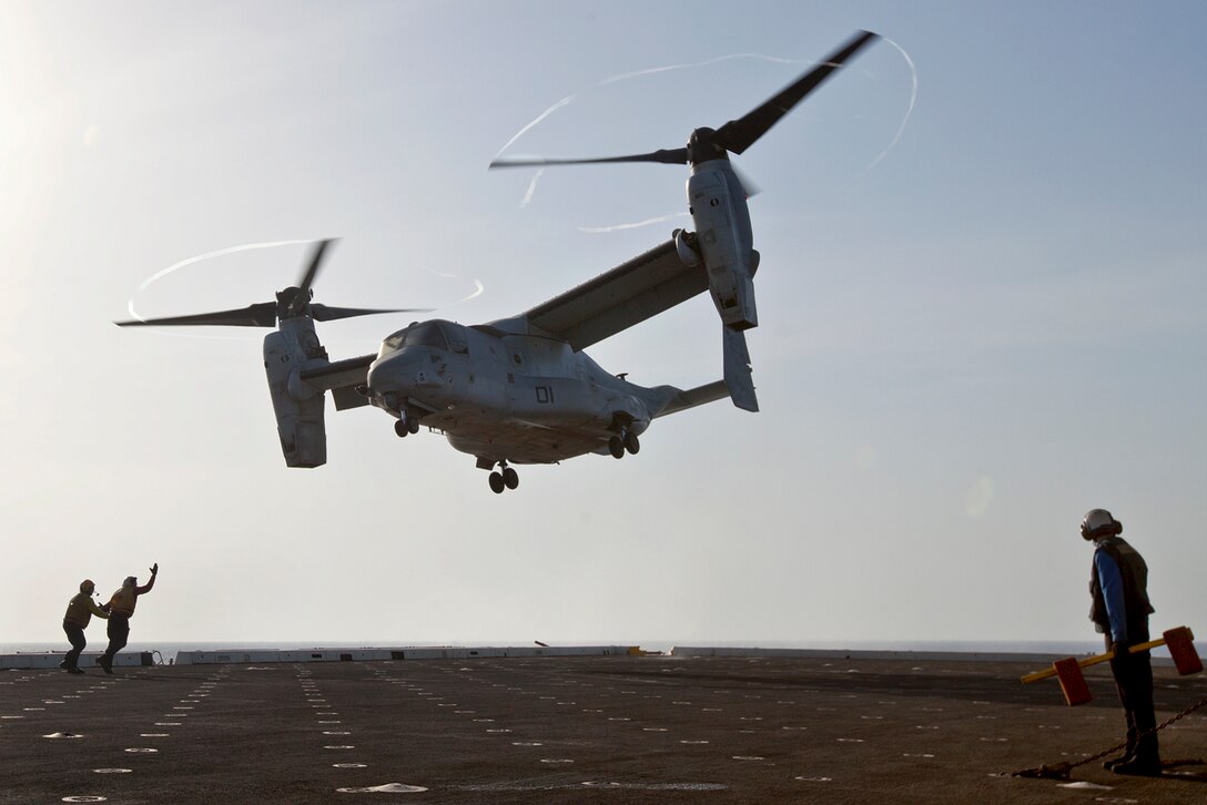 U.S. sailors aboard the amphibious transport dock ship USS Mesa Verde guide a U.S. Marine Corps MV-22 Osprey aircraft as it departs to support ongoing operations in the Persian Gulf, June 16, 2014.