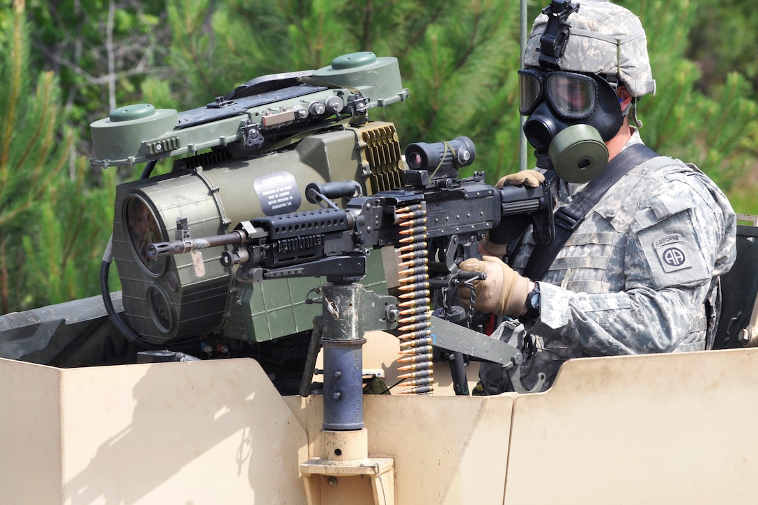 A paratrooper aims his M249 machine gun from the gunner's turret on a tactical vehicle 
during a live-fire exercise on Fort Pickett, Va., June 8, 2014.