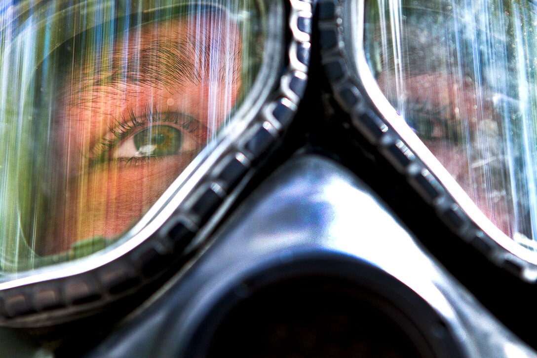 A soldier wearing a gas mask prepares to enter a chamber of tear gas during training on Fort Bragg, N.C., Oct. 3, 2011. The soldier, a medic, is assigned to the 82nd Airborne Division’s 1st Brigade Combat Team. Soldiers must periodically show they are proficient at donning and sealing a gas mask under the duress of contact with a gas irritant such as tear gas.  
