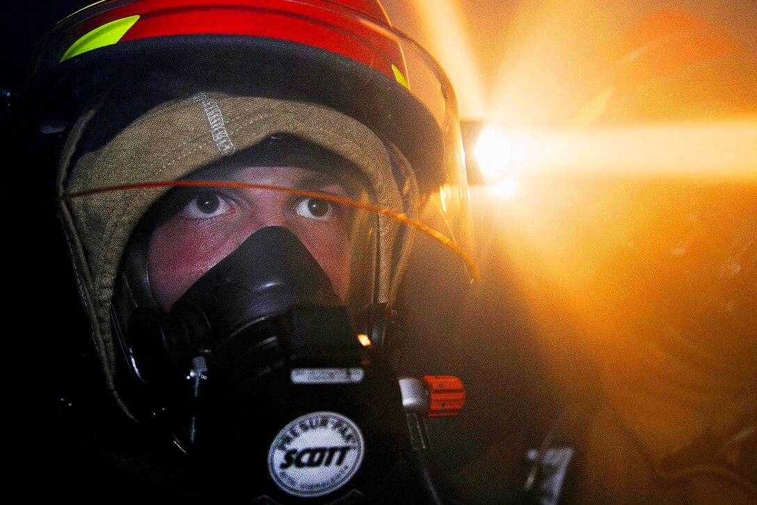 A U.S. Navy sailor practices firefighting during a general quarters drill in the hangar bay aboard the aircraft carrier USS Abraham Lincoln in the Pacific Ocean, Sept. 17, 2011. The Abraham Lincoln is under way conducting an exercise to train all sailors assigned to the ship to function as an effective fighting force.  
