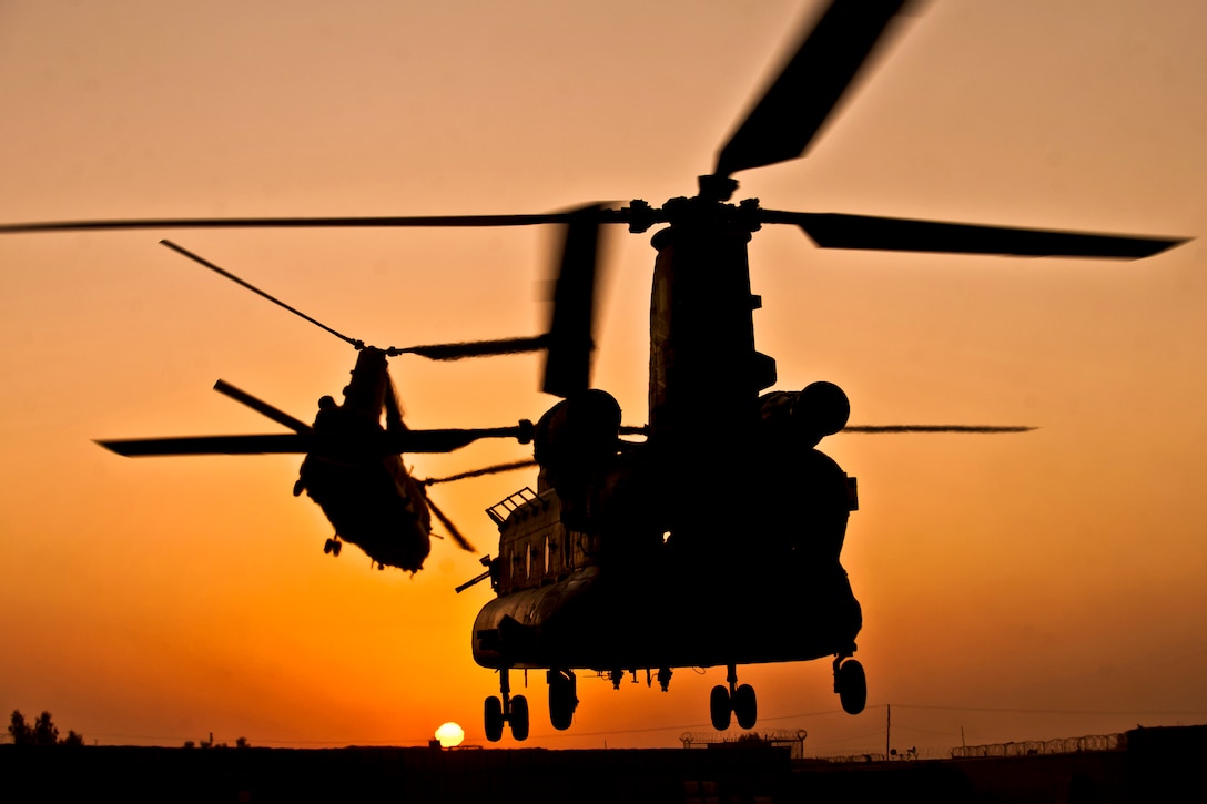 Two Royal air force CH-47 Chinook helicopters take off from Task Force Helmand headquarters in the Lashkar Gah district in Afghanistan's Helmand province, Sept. 22, 2011.  
