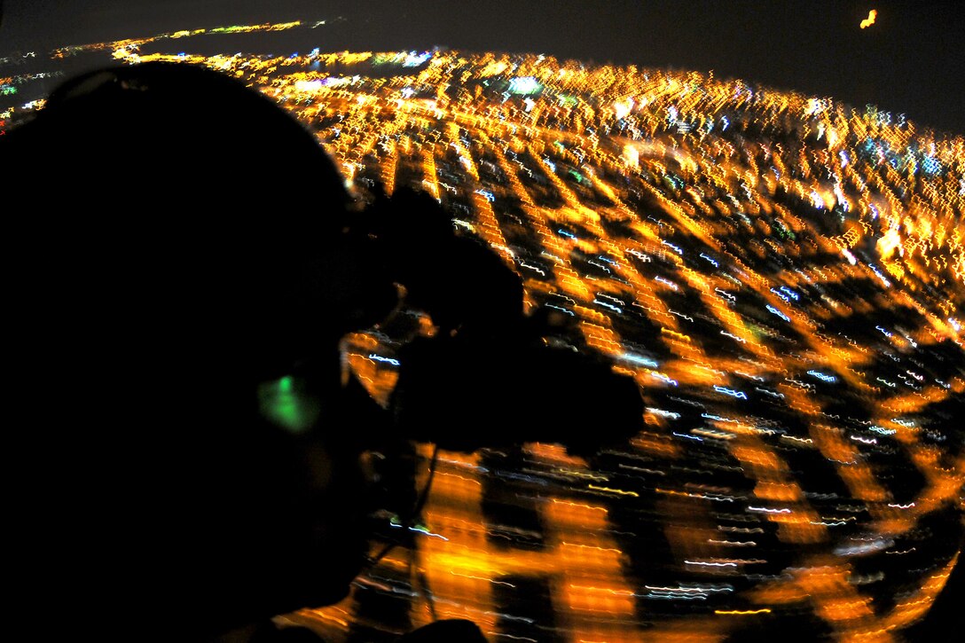 A U.S. Navy crew chief scans the horizon with his night vision goggles as a MH-60S Sea Hawk flies toward a forward area refueling point training event during Jackal Stone 2011 on Mihail Kogalniceanu Air Base, Romania, Sept. 16, 2011. The crew chief is assigned to Helicopter Sea Combat 28. Jackal Stone was created to enhance special operations forces capacity and interoperability among the nine participating nations.  
