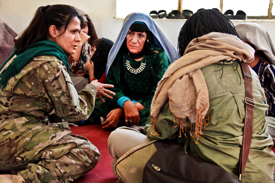 U.S. soldiers speak with Afghan women at the district center in Spin Boldak City, Kandahar province, Afghanistan, Sept. 18, 2011. The soldiers, assigned to the 504th Battlefield Support Brigade, supported a locally-run health education event for Afghan women and their children.  
