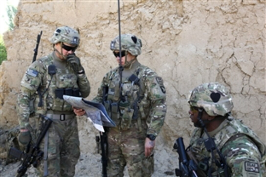 U.S. Army 1st Lts. Matthew White, left, and Kenneth Hurst, center, hold a map while talking with U.S. Army Capt. Rodney Freeman, right, about the plan of movement for a patrol through Petawa village in Afghanistan's Parwan province, June 13, 2014. White, Hurst and Freeman are assigned to the 101st Airborne Division's Company A, 1st Battalion, 2nd Brigade Combat Team, Task Force Strike. The soldiers patrolled to disrupt enemy activity during the Afghan elections.
