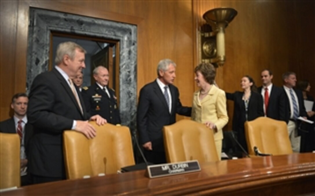 Defense Secretary Chuck Hagel talks with U.S. Senator Susan Collins shortly before testifying before the Senate Appropriations Committee’s defense subcommittee in Washington D.C., June 18, 2014, on the Defense Department’s fiscal year 2015 budget request. Army Gen. Martin E. Dempsey, chairman of the Joint Chiefs of Staff, and Robert Hale, Defense Department comptroller, who arrived with Hagel, also testified.