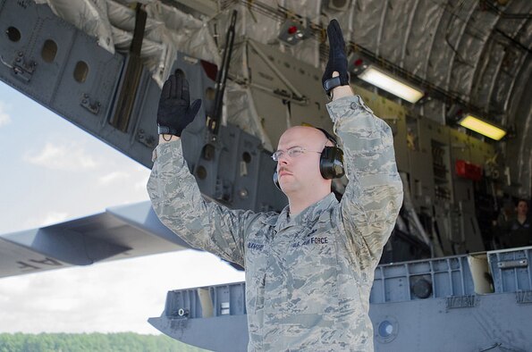 Tech. Sgt. Jerrod Blanford, an aerial porter from the Kentucky Air National Guard’s 123rd Contingency Response Group, spots a forklift as it unloads cargo from a Kentucky Air Guard C-130 Hercules during Capstone '14, a homeland earthquake-response exercise at Fort Campbell, Ky., on June 17, 2014. The 123rd CRG is joining with the U.S. Army’s 688th Rapid Port Opening Element to operate a Joint Task Force-Port Opening here from June 16 to 19, 2014. (U.S. Air National Guard photo by Master Sgt. Phil Speck)