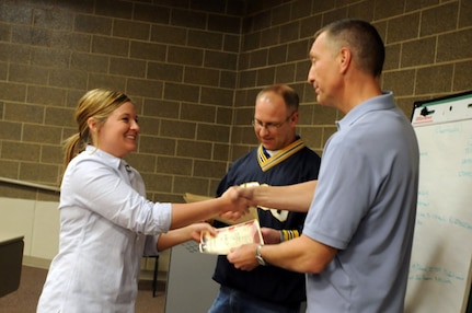 Army Sgt. Ashley Zerfas, 153rd Engineer Battalion, left, accepts her certificate from Army Lt. Col. Doug Bogenhagen, South Dakota Army National Guard Counterdrug branch chief, after completing the Unit Prevention Leader course at the 196th Regional Training Institute in Sioux Falls, S.D., March 30, 2012. Zerfas, along with 47 other students who attended the class, gained the tools to be able to help educate, prevent and monitor substance abuse among fellow service members in the Guard.